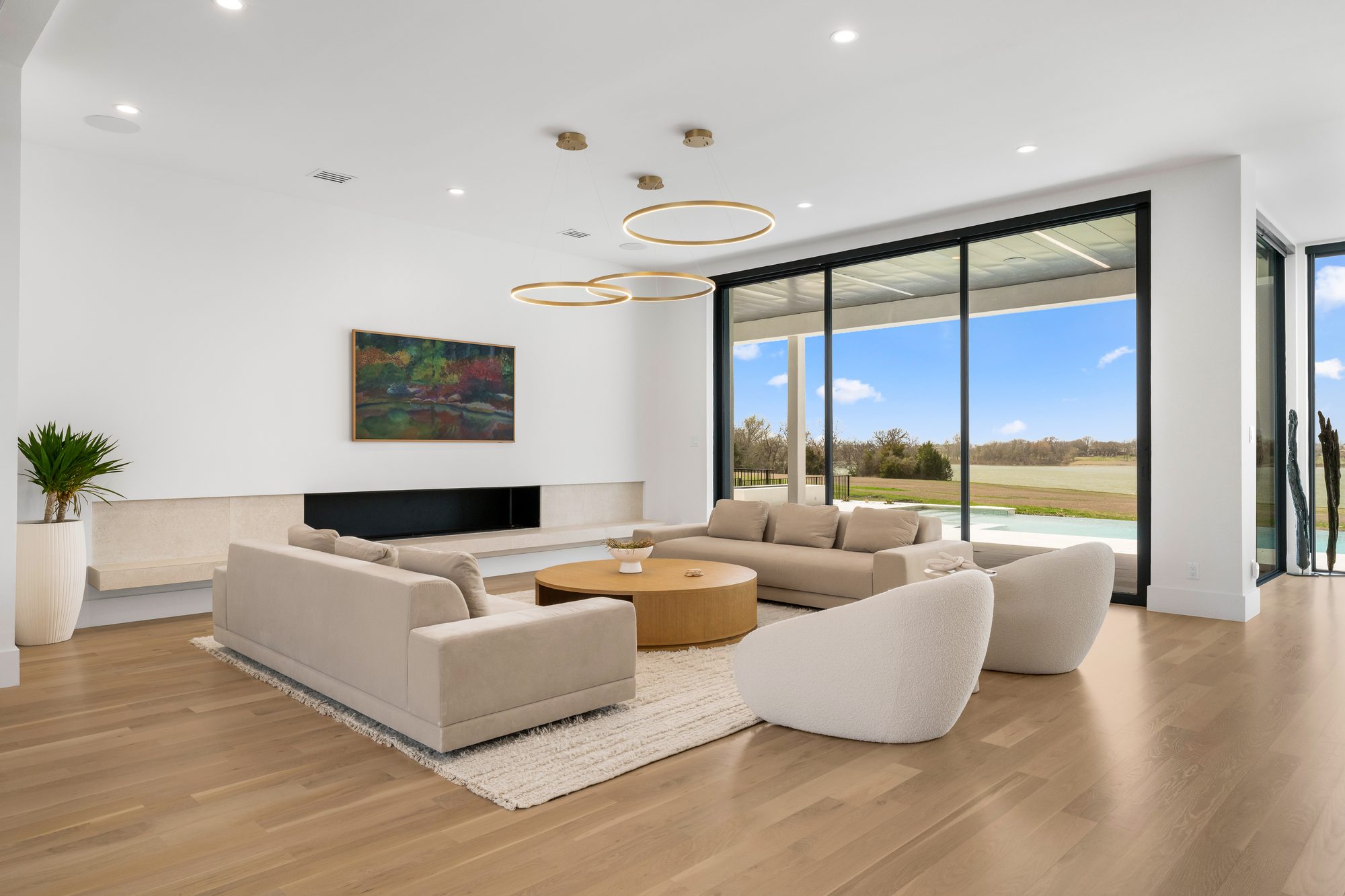 Living room seating group with the fireplace wall and sliding glass to the covered patio