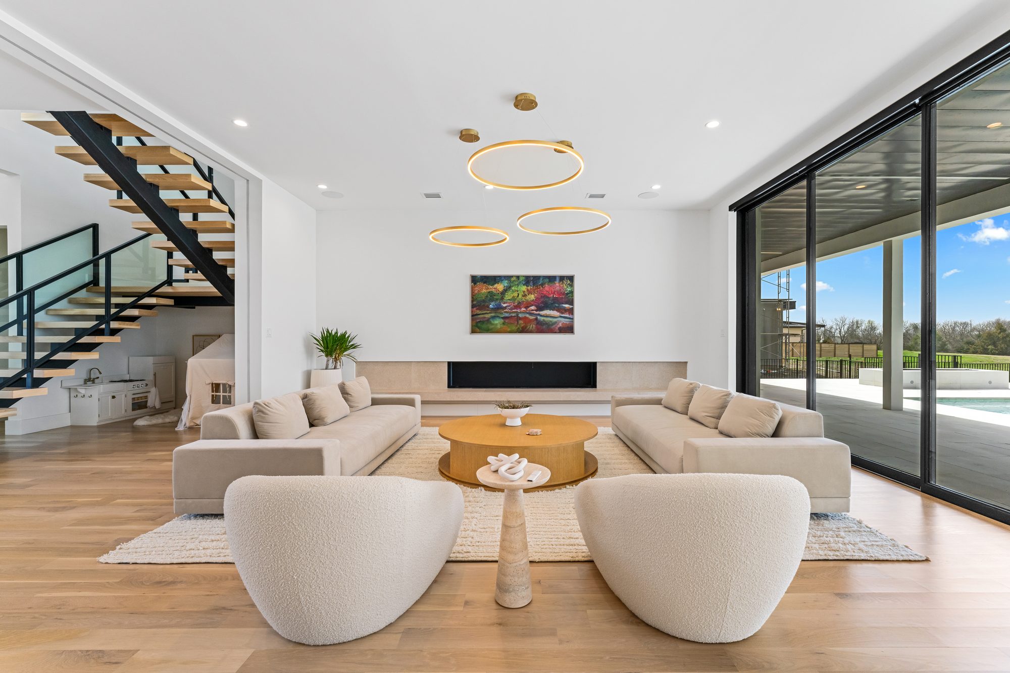 Great room with the floating staircase and a long linear fireplace